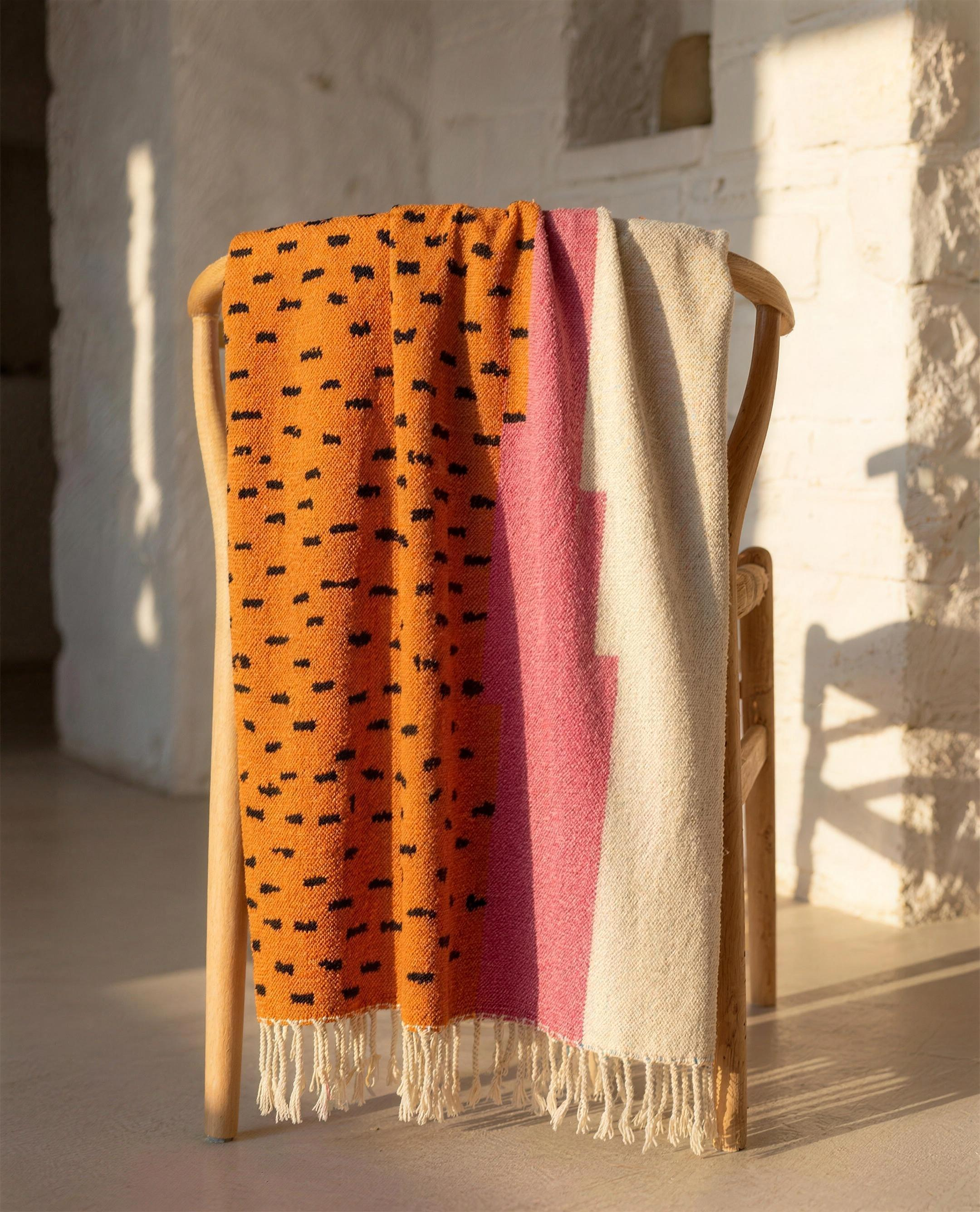 Atlas Berber throw blanket draped over a chair with fringe, full view
