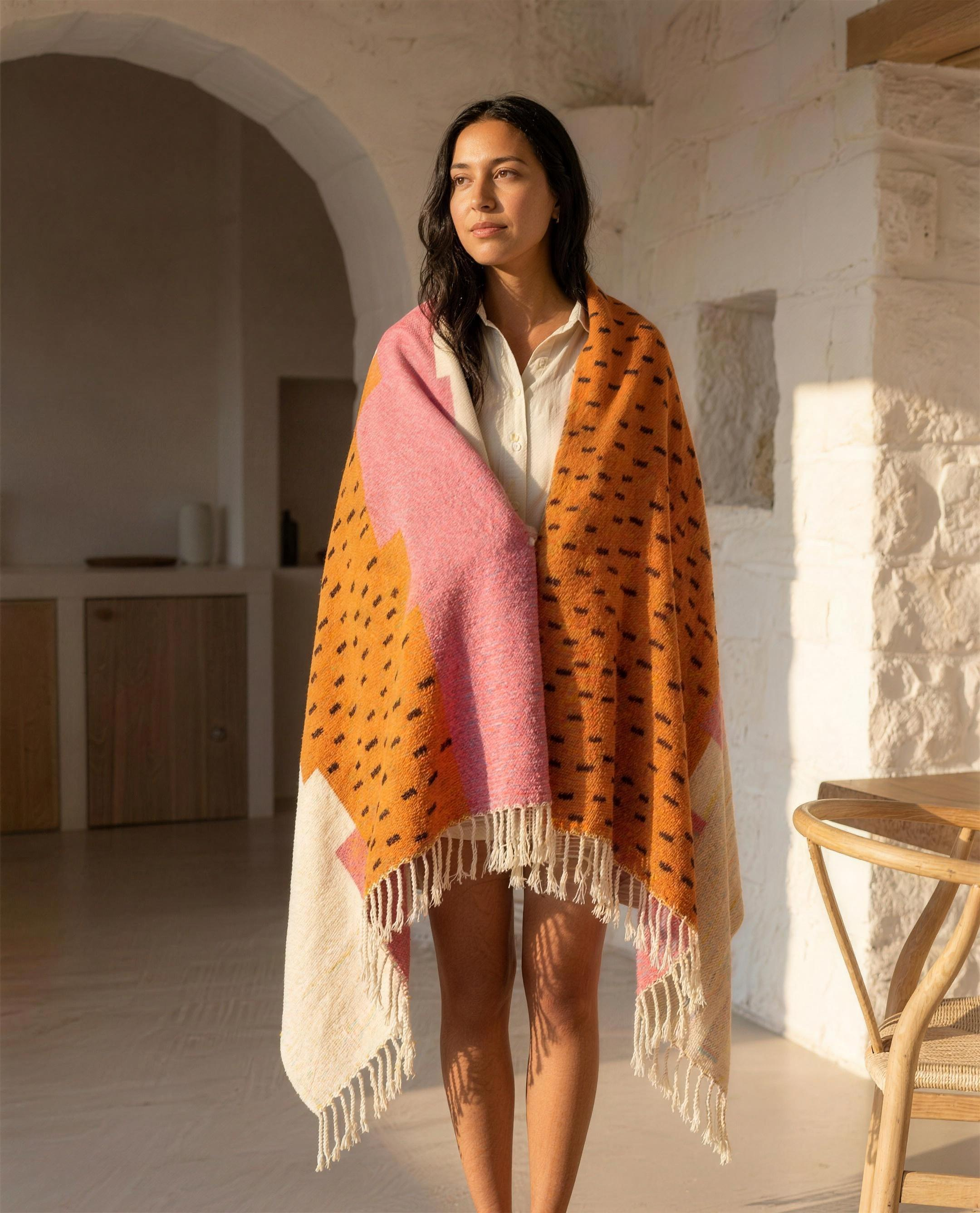 Woman wrapped in the Atlas Berber throw blanket in a Mediterranean home