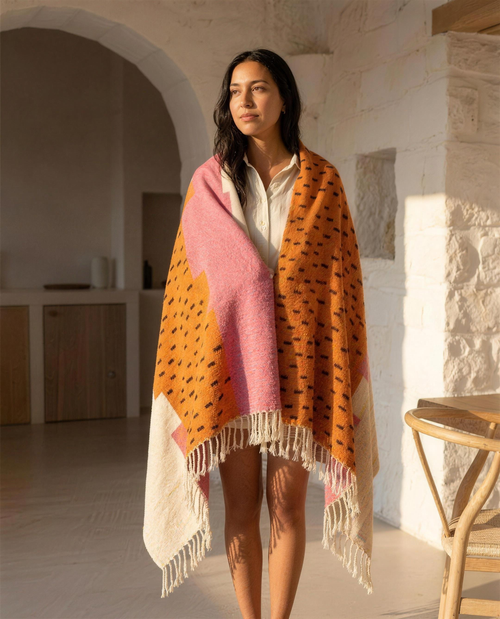 Woman wrapped in the Atlas Berber throw blanket in a Mediterranean home