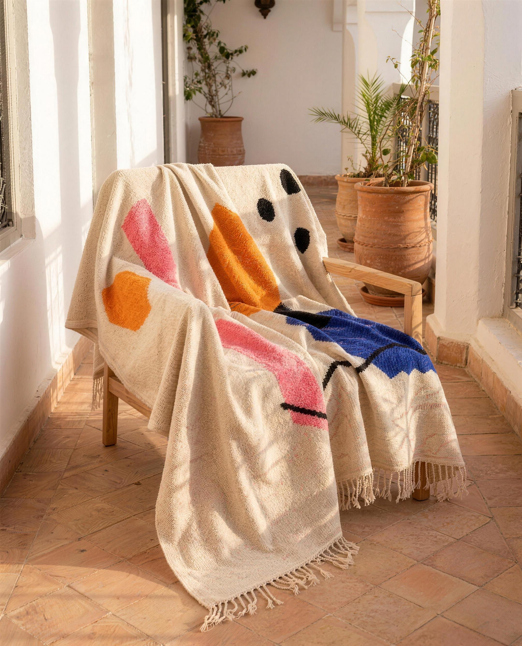 Atlas tribal Berber throw draped over a chair, full view with fringe
