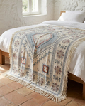 Marrakech medallion throw laid neatly on a made bed in a Mediterranean villa